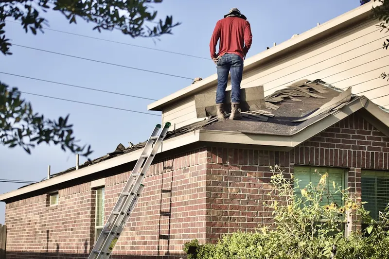 Professional roofer working on a residential roof in Downtown Nashua